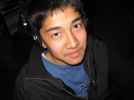 Niyaz wearing headphones at a computer club